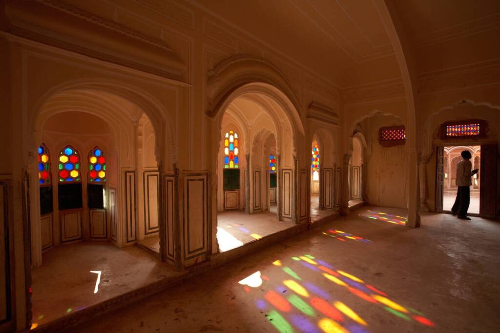 unlight-streaming-through-colorful-window-glasses-creating-intricate-patterns-on-the-floors-and-walls-of-Hawa-Mahal-Jaipur