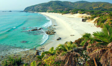 Tranquil shores and lush hills frame the pristine beauty of South Cinque Island Beach in the Andaman and Nicobar Islands