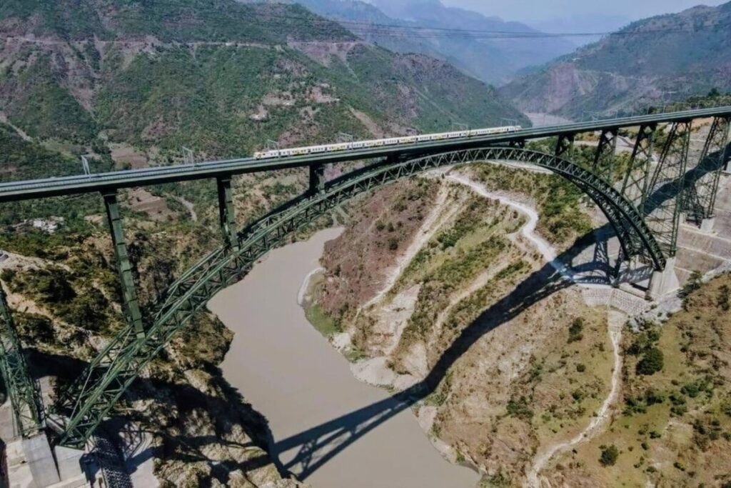 Drone View of The Chenab Railway Arch Bridge in the Kashmir Valley with Train Passing over It.