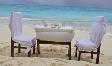 SetMyTrip 4 Nights Lakshadweep Agatti Beach Resort Stay Package (Honeymoon Special)– includes a private beach celebration set-up with an intimate dining table arranged on the white sands of Agatti Island, offering couples a romantic daytime experience by the turquoise sea.