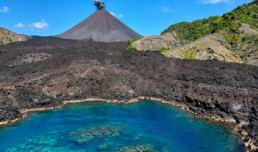 Barren Island active volcano with black lava fields and turquoise sea in the Andaman Islands