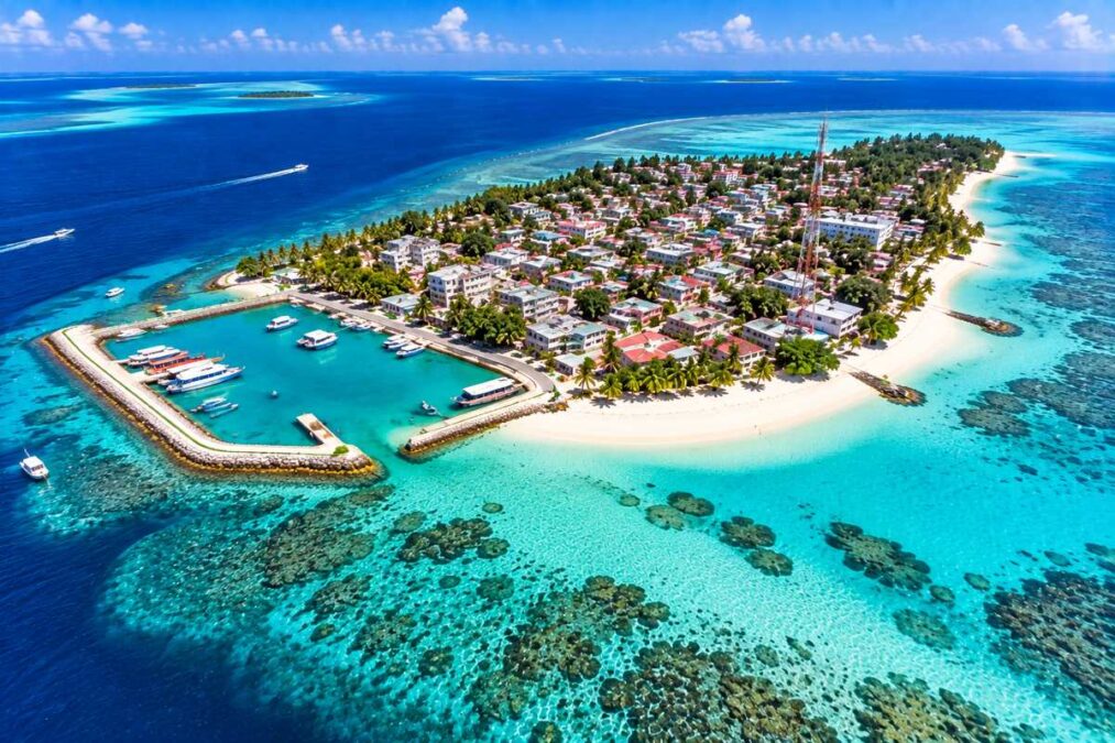 Aerial view of Guraidhoo Island Maldives with harbour, village, white beaches and turquoise lagoon